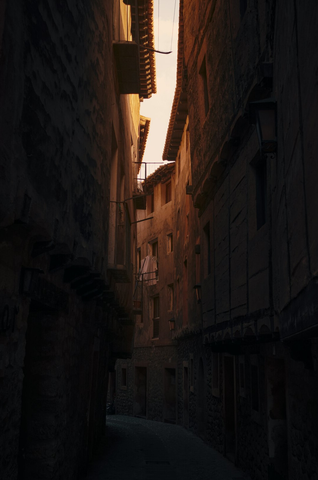 Atmospheric old city street at dusk with warm lights