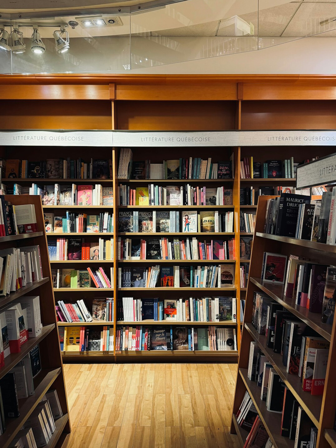 Quiet library with tall wooden shelves full of books